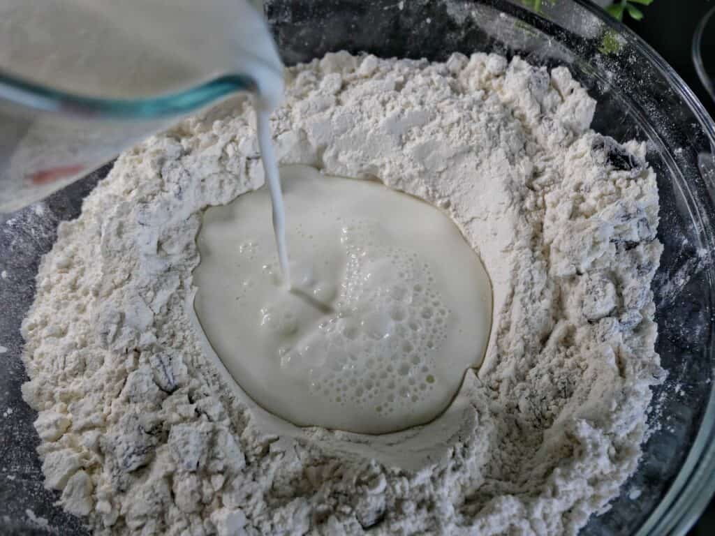 Pouring wet ingredients into the flour mixture