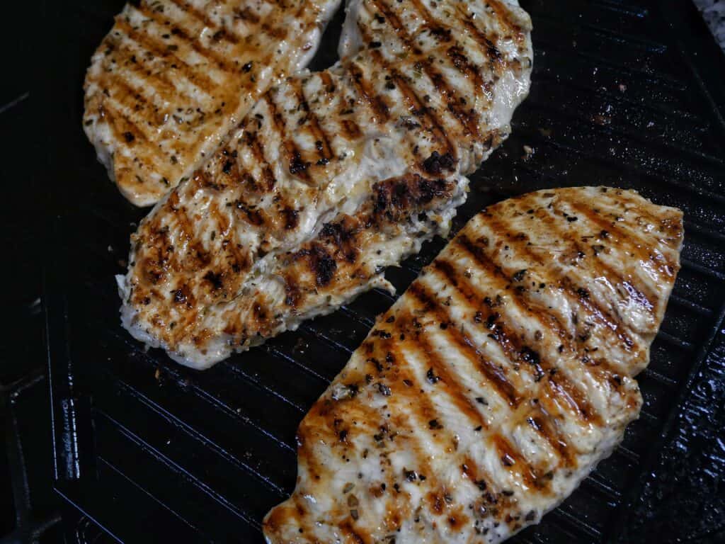 chicken grilling on a grill plate