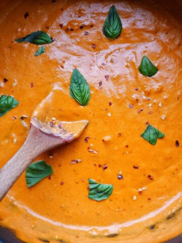 vodka sauce in a pot with basil and red pepper flakes